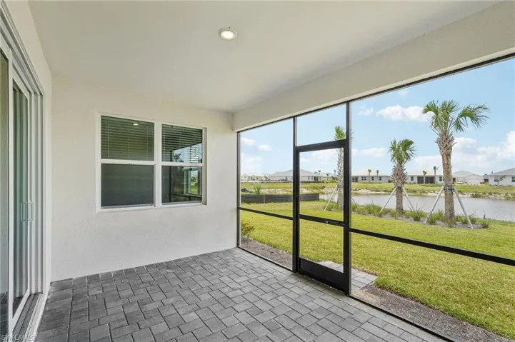 Unfurnished sunroom with a water view and a residential view