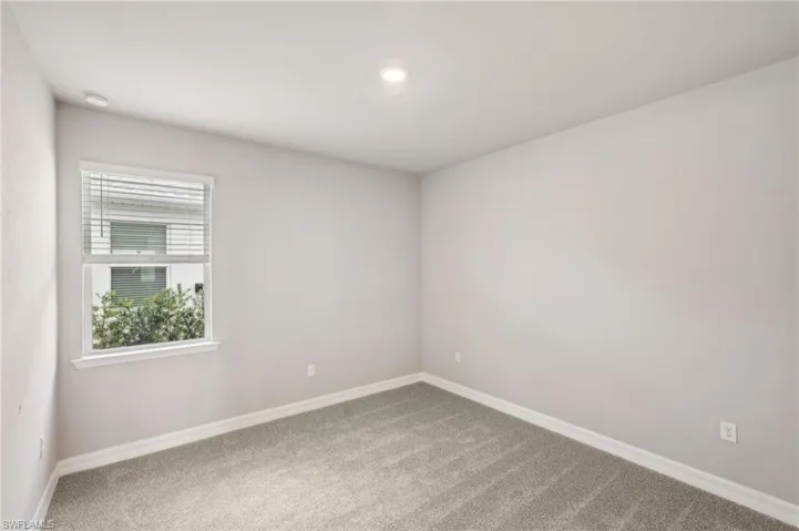 Unfurnished room featuring carpet, baseboards, recessed lighting, and a smoke detector