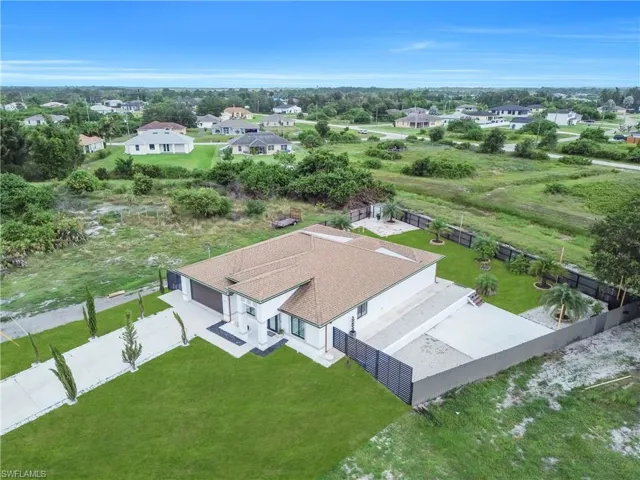 Contemporary single-story residence with a brown shingle roof, white stucco exterior, and attached garage