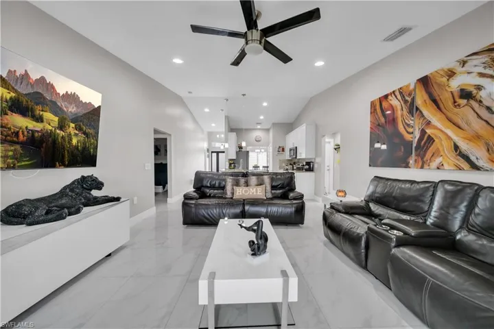 Vaulted ceiling featuring recessed lighting and a ceiling fan