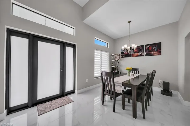 Entryway featuring a double door with frosted glass panels, transom windows, and a sidelight