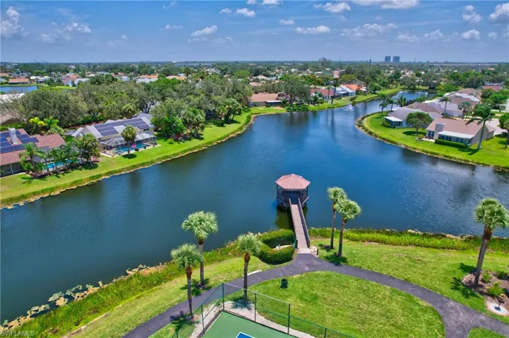 Aerial perspective of suburban area featuring a nearby body of water