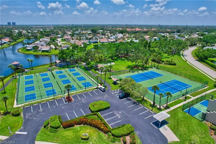 Aerial perspective of suburban area featuring a nearby body of water