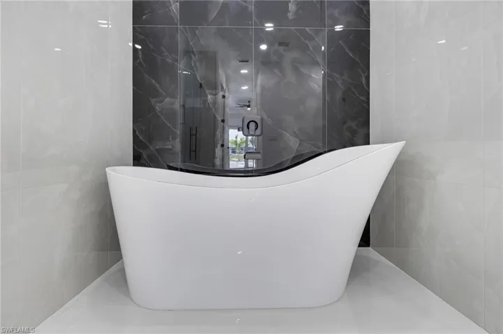Bathroom with tile walls and a freestanding bath
