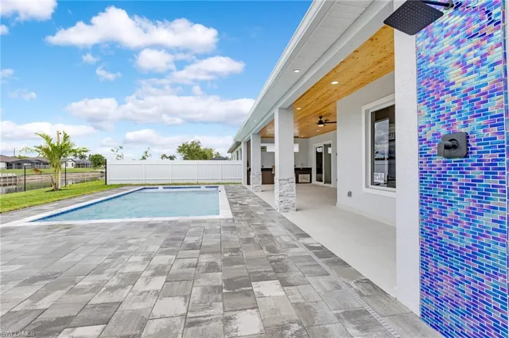 View of pool with a patio and a ceiling fan