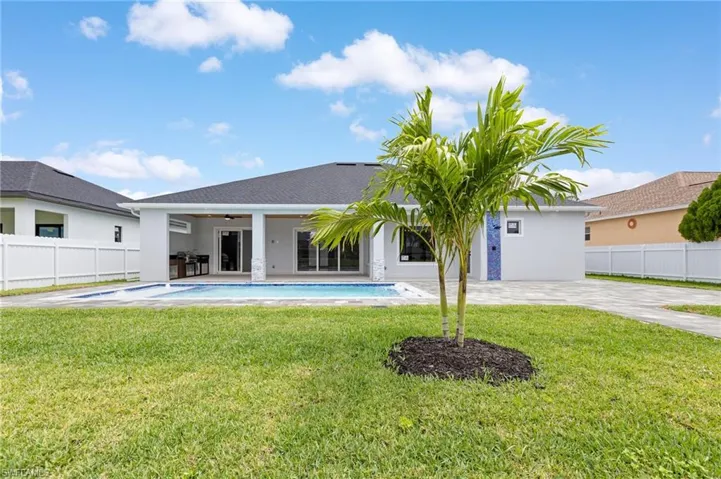 Back of property with a patio area, stucco siding, and ceiling fan