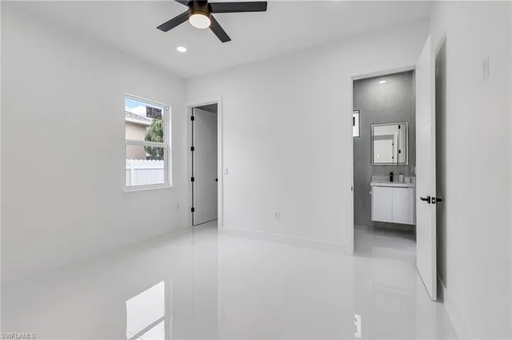 Unfurnished bedroom featuring recessed lighting, light tile patterned floors, and a ceiling fan