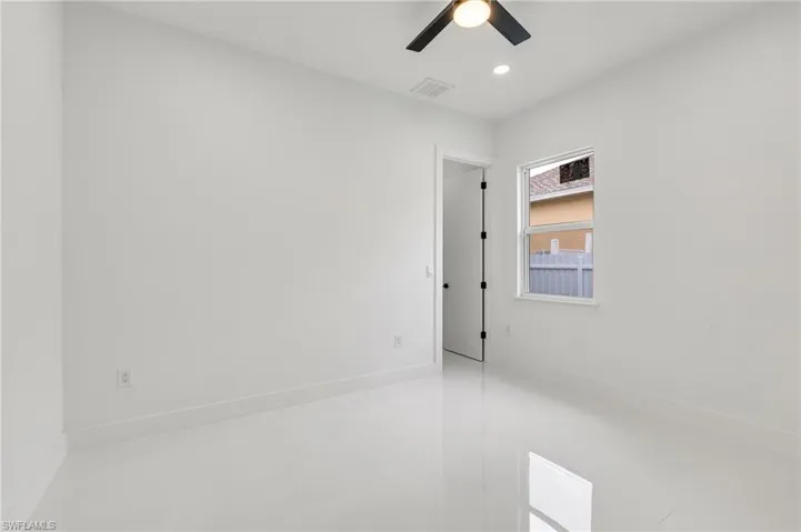 Empty room featuring baseboards and recessed lighting