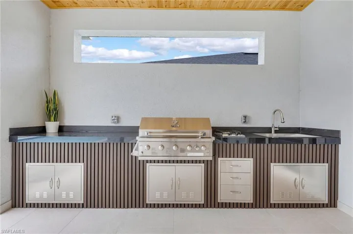 View of patio / terrace with an outdoor kitchen and a sink