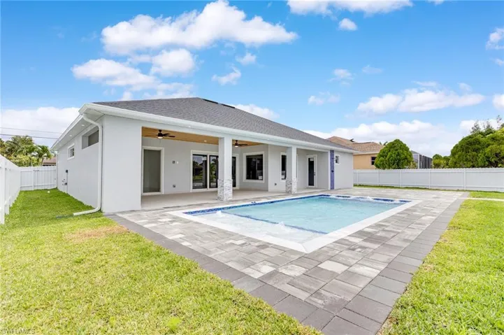 View of swimming pool featuring a fenced backyard, ceiling fan, and a patio area