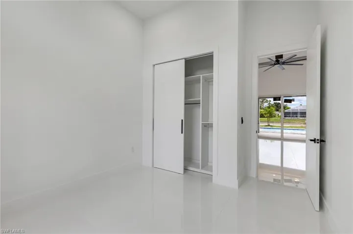 Unfurnished bedroom featuring light tile patterned flooring and a closet