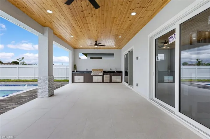 View of patio / terrace featuring area for grilling and a ceiling fan
