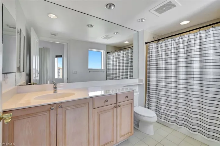 Bathroom featuring vanity, light tile patterned floors, and recessed lighting