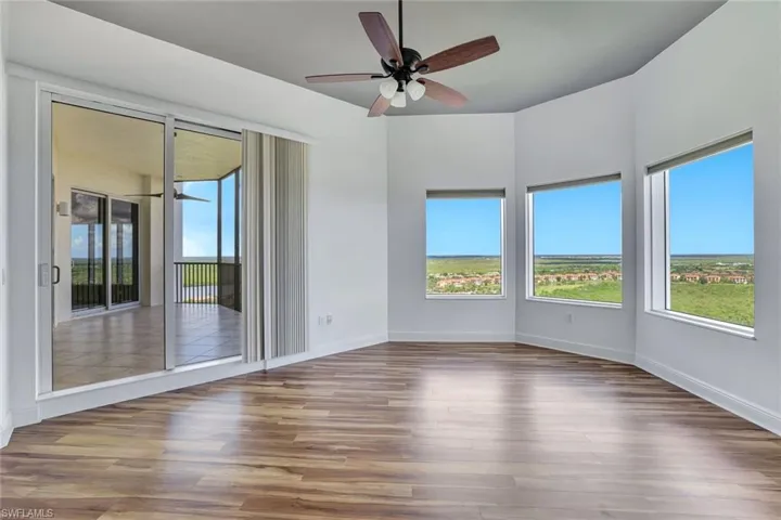 Spare room with wood finished floors and ceiling fan