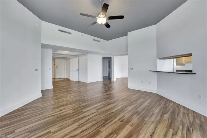 Unfurnished living room with light wood-style flooring and ceiling fan