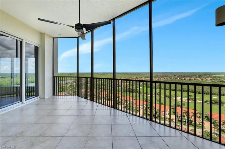 Unfurnished sunroom with expansive windows, a textured ceiling, and tile patterned floors