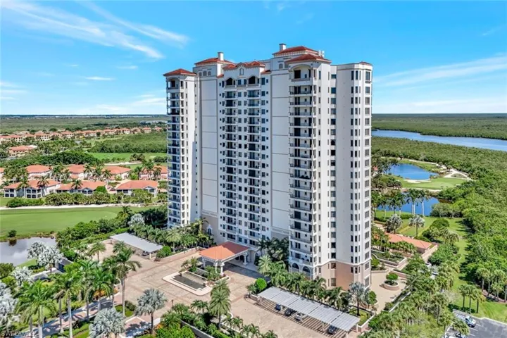 View of apartment building / complex featuring a water view and golf course view