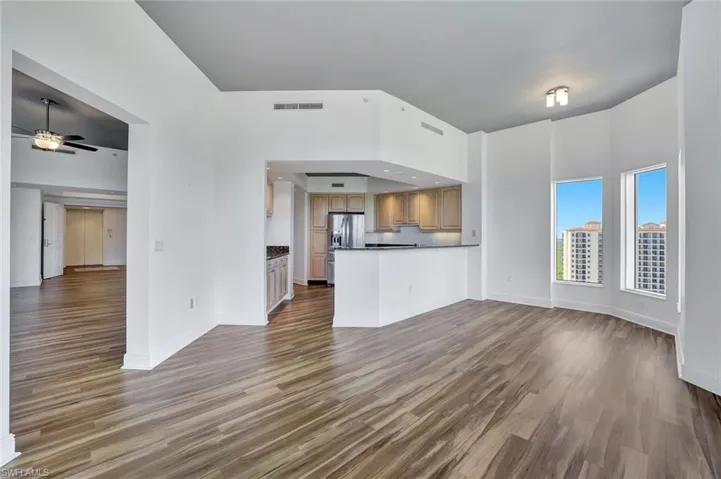 Unfurnished living room with light wood-type flooring and ceiling fan