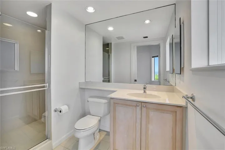 Full bathroom with vanity, a shower stall, recessed lighting, and light tile patterned flooring