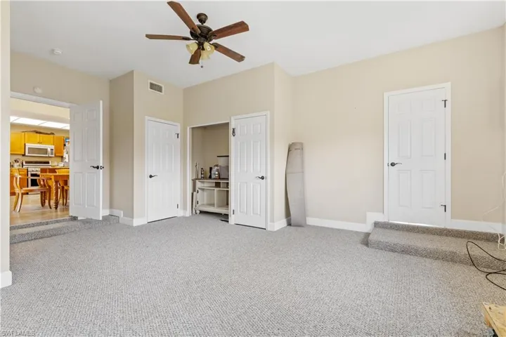 Unfurnished bedroom featuring carpet flooring and ceiling fan