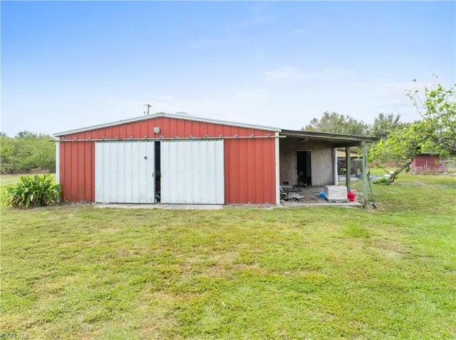 View of outbuilding featuring a yard