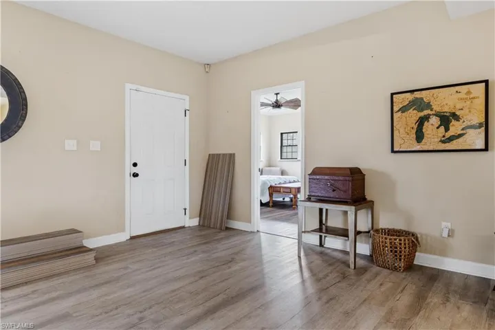 Foyer with ceiling fan and light hardwood / wood-style flooring