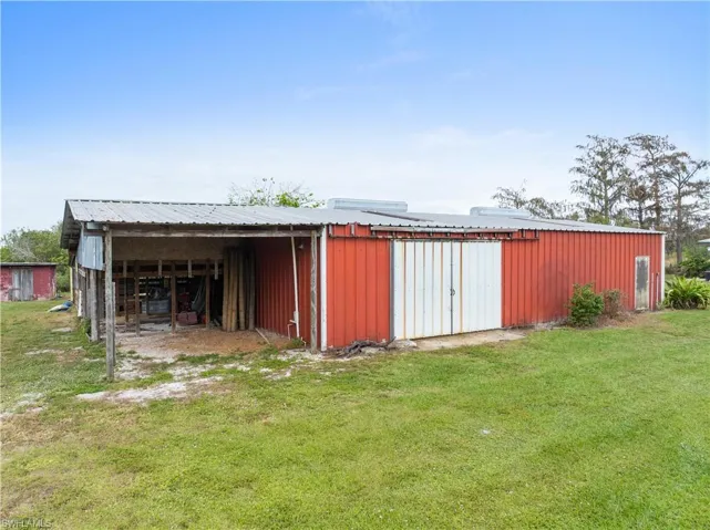 View of outdoor structure with a lawn