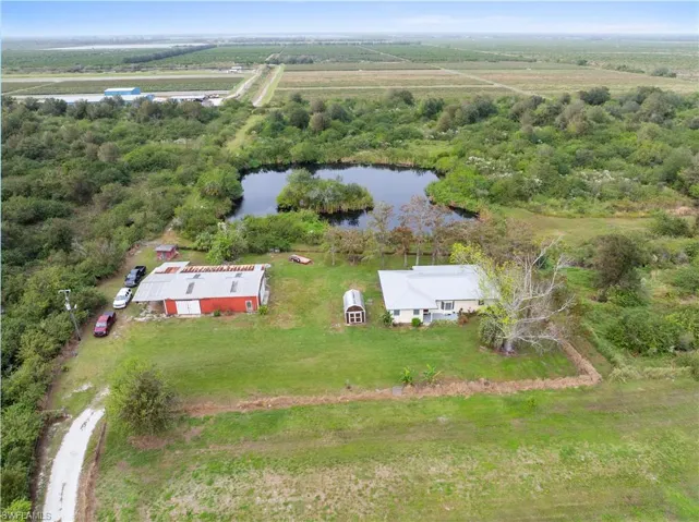 Birds eye view of property featuring a rural view and a water view