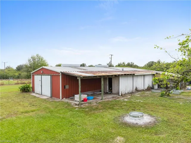 View of outdoor structure featuring a yard