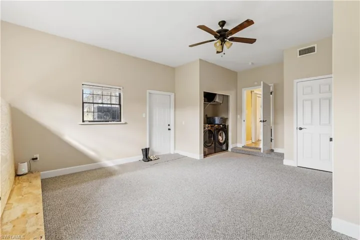 Spare room featuring carpet floors and ceiling fan