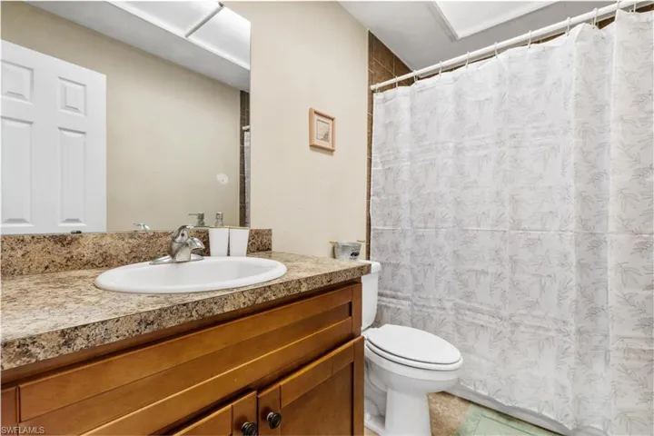 Bathroom featuring tile patterned floors, vanity, and toilet