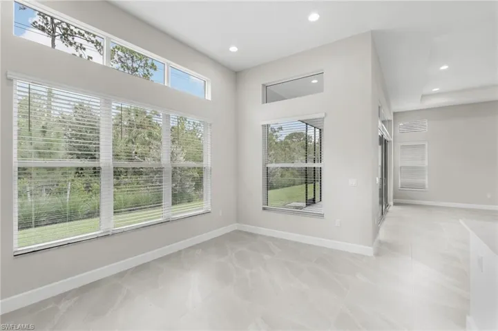 Large dining area with soaring ceilings and transom windows.