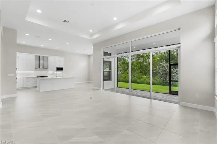 Spacious open floor plan with 12' ceilings featuring transom windows for elegance and natural light