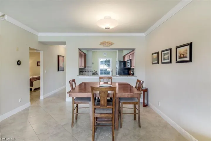 Dining room featuring crown molding and light tile patterned floors