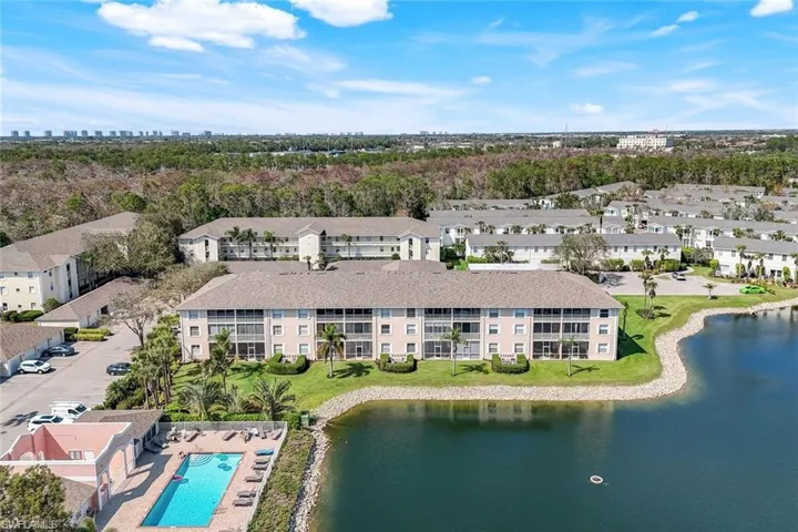 Aerial view of apartment complex / building and a nearby body of water