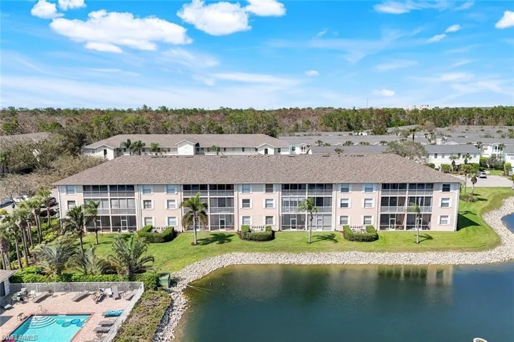 Drone / aerial view of apartment complex and a nearby body of water