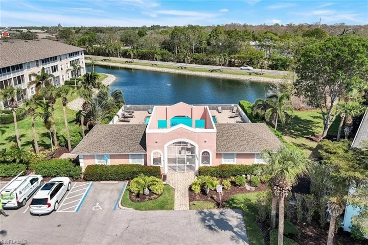 Drone / aerial view of a nearby body of water and a tree filled landscape
