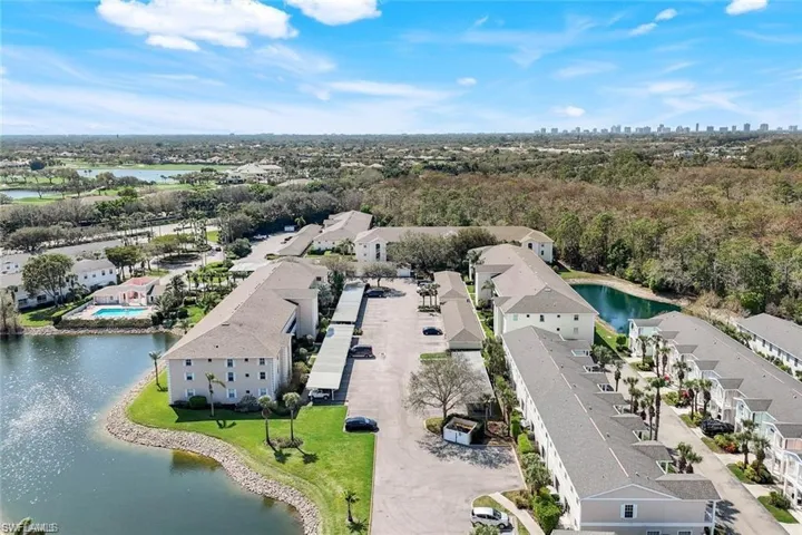 Aerial view of a nearby body of water and apartment complex / building