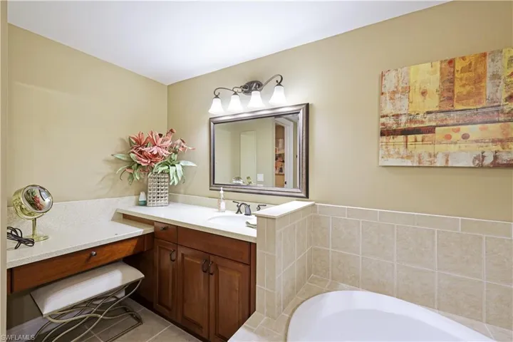 Bathroom featuring a tub, tile patterned floors, and vanity