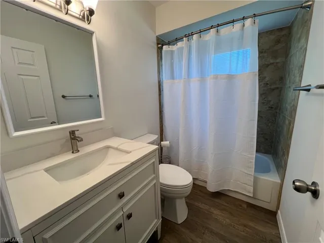 Guest bathroom with new toilet and vanity, shower / tub combo