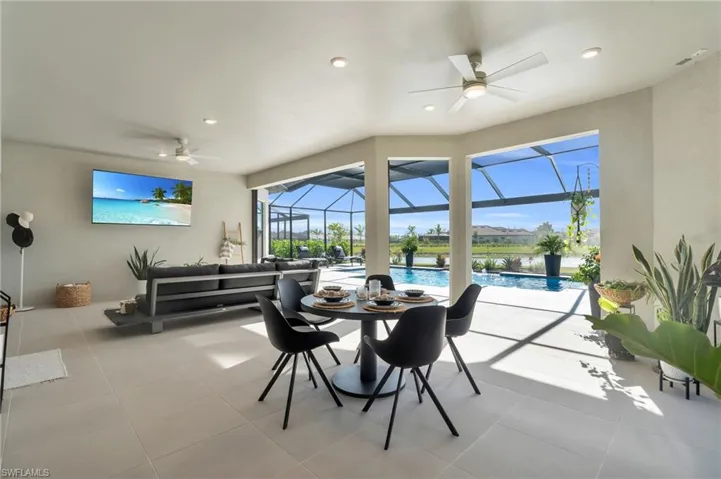 Dining area with ceiling fan, plenty of natural light, and light tile patterned floors