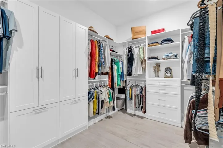 Spacious closet featuring light hardwood / wood-style floors