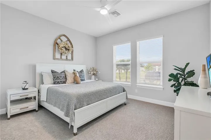 Bedroom with light carpet and ceiling fan