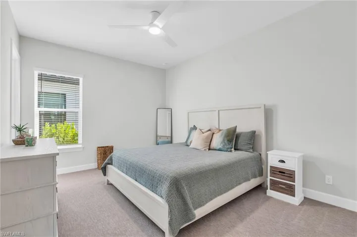 Bedroom featuring ceiling fan and carpet floors
