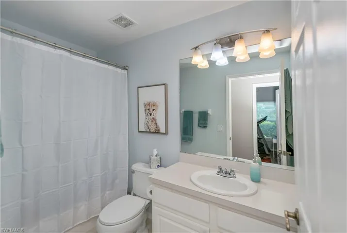 Bathroom featuring vanity and curtained shower