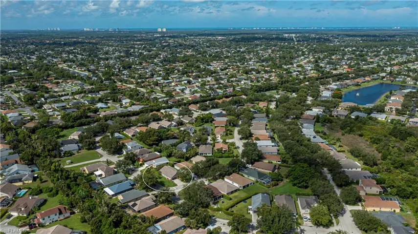 Aerial view of property's location with nearby suburban area