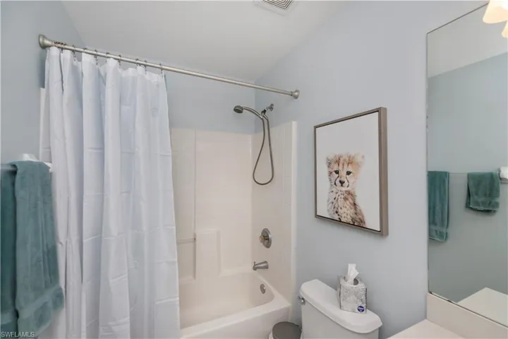 Bathroom with shower / bath combo and vanity