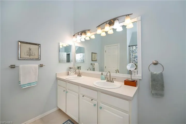 Bathroom featuring double vanity and tile patterned floors