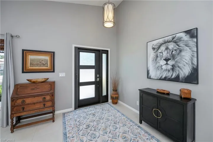 Entrance foyer with a towering ceiling and light tile patterned floors