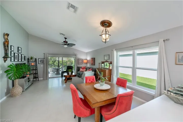 Dining area featuring vaulted ceiling and ceiling fan